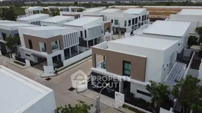Modern residential neighborhood with contemporary houses and clean streets, showcasing sleek architectural design.