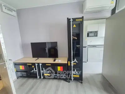 Modern living room with industrial decor and sleek kitchen view