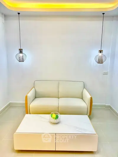Modern minimalist living room with stylish lighting and cozy sofa