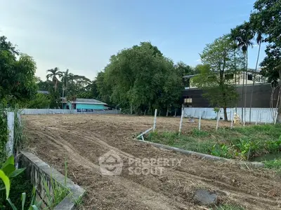 Spacious vacant land plot surrounded by lush greenery, ideal for development opportunities.