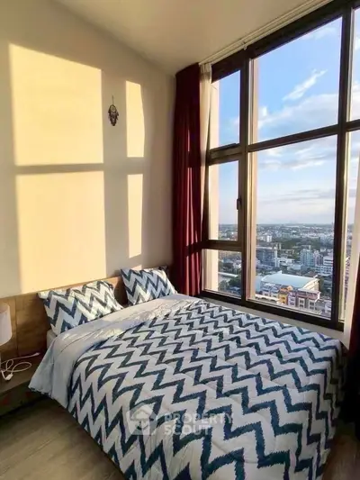 Stunning bedroom with floor-to-ceiling windows offering breathtaking city views and modern decor.