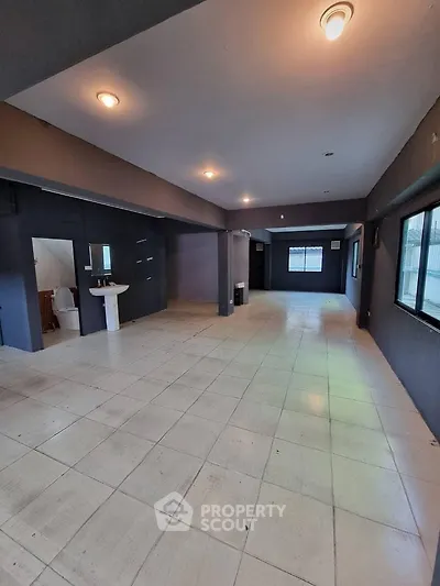 Spacious open-plan interior with tiled flooring and ample natural light, ideal for versatile living or commercial use.