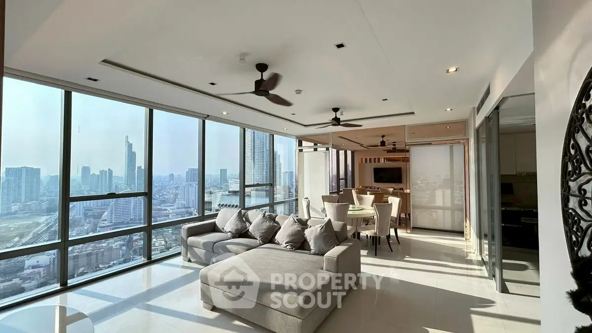 Luxurious corner unit living room with panoramic city views and modern furnishings.