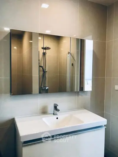 Modern bathroom with sleek vanity and large mirror, perfect for contemporary living.