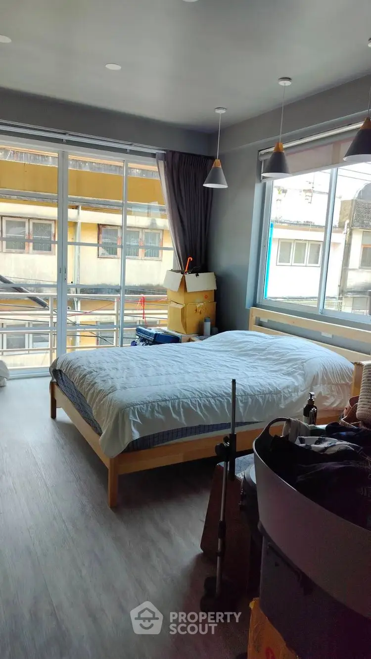 Spacious bedroom with large windows and modern decor