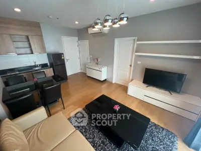 Modern living room with open kitchen, sleek furniture, and stylish decor in a contemporary apartment.