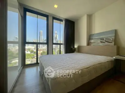 Modern bedroom with city view and large windows in high-rise apartment