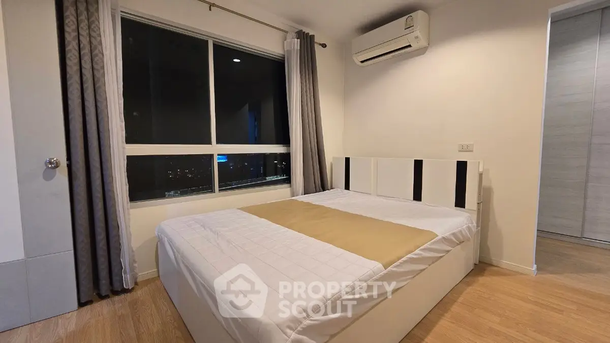 Modern bedroom with large window and air conditioning unit