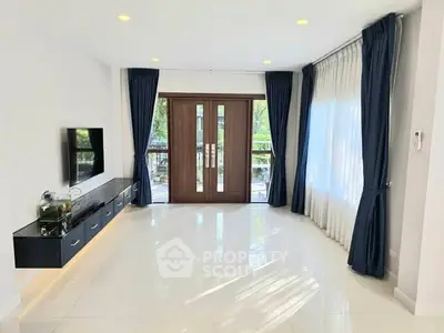 Spacious living room with modern decor and large windows for natural light