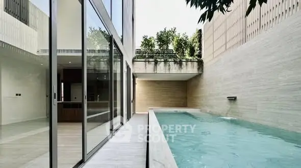 Luxurious modern home with sleek private pool and spacious open layout.