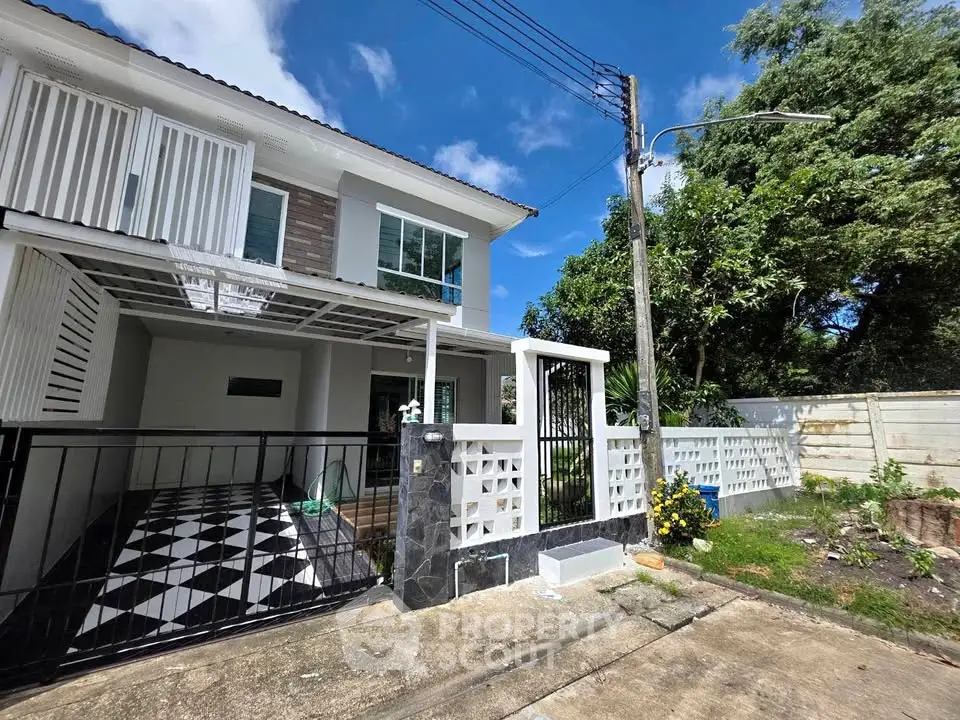 Modern two-story house with stylish facade and spacious driveway in a serene neighborhood.