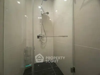 Modern bathroom with sleek shower and glass enclosure in contemporary home.