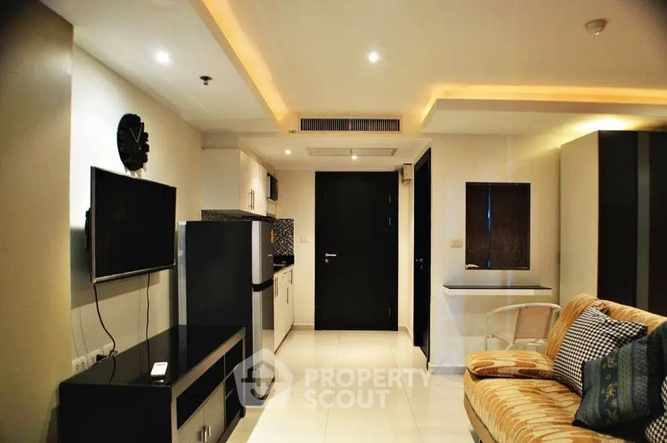 Modern living room with sleek design and integrated kitchen area
