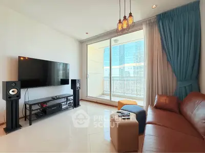 Modern living room with large TV and balcony view in high-rise apartment.