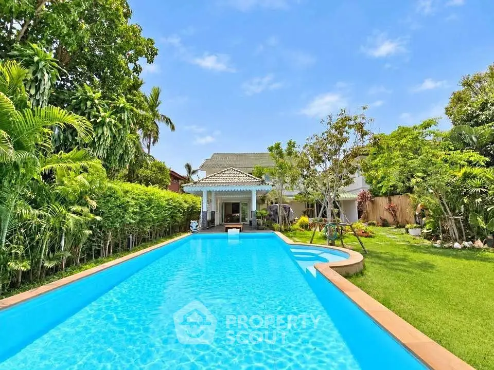 Luxurious villa with stunning pool and lush garden, perfect for relaxation and entertainment.
