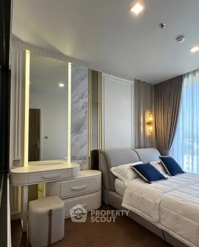 Luxurious bedroom with elegant decor and modern lighting, featuring a cozy bed and stylish vanity area.
