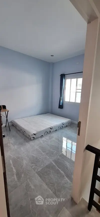 Minimalist bedroom with floor mattress and natural light