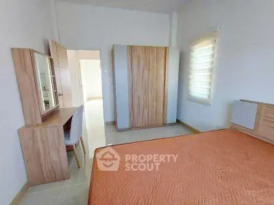 Spacious bedroom with modern wooden furniture and natural light