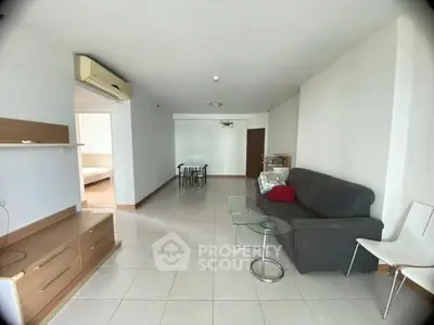 Spacious living room with modern furniture and air conditioning in a bright apartment.