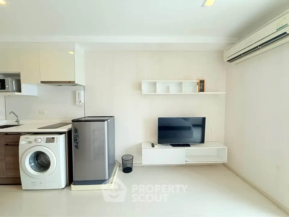 Modern living room with washing machine and air conditioning in a stylish apartment.