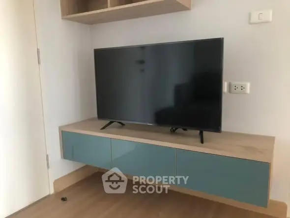 Modern living room with sleek TV unit and wooden flooring