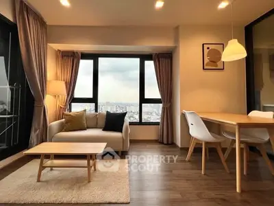 Modern living room with city view, stylish furniture, and warm lighting.