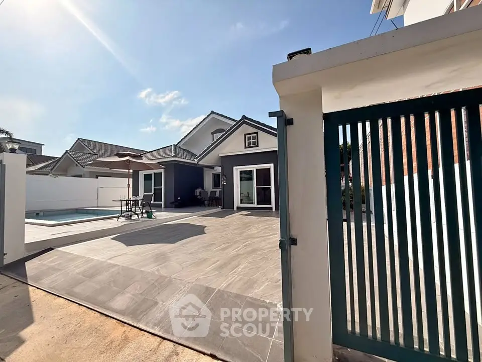 Charming suburban home with pool and spacious patio, perfect for outdoor entertaining.