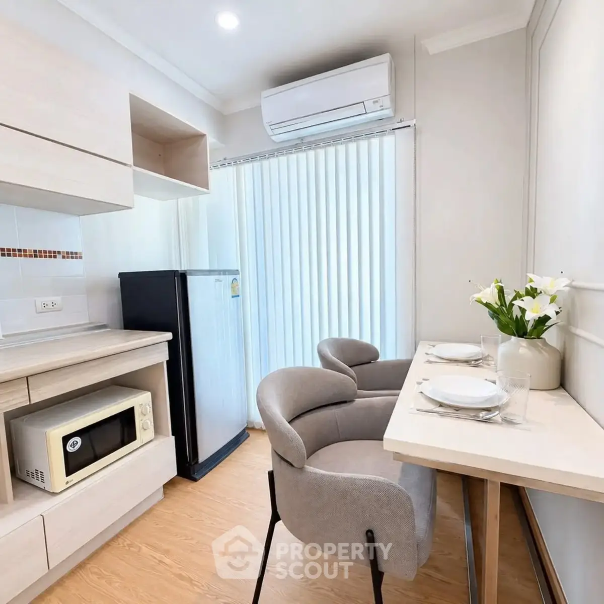 Cozy kitchen with dining area, featuring modern appliances and elegant decor, perfect for urban living.