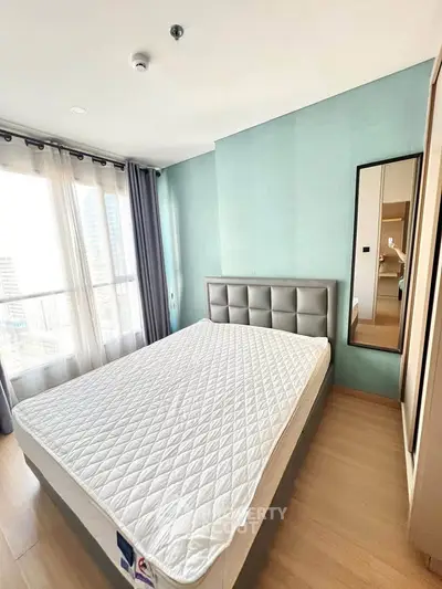 Modern bedroom with large window and stylish decor in high-rise apartment