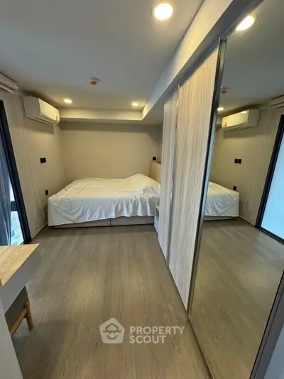 Modern bedroom with mirrored closet and minimalist design