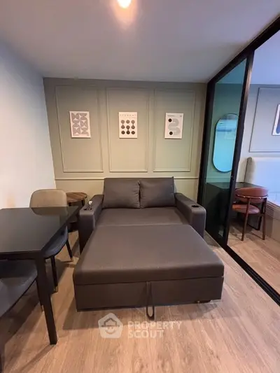 Modern living room with stylish sofa bed and elegant decor in a cozy apartment setting.