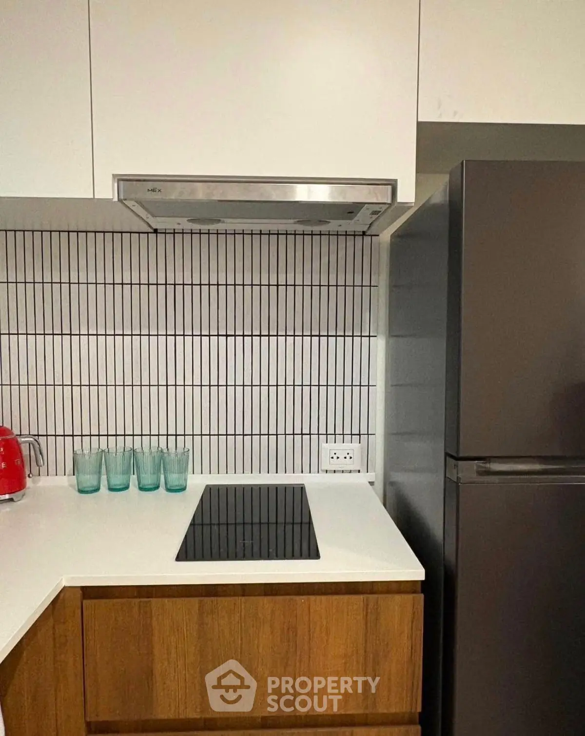 Modern kitchen with sleek cooktop and stylish backsplash