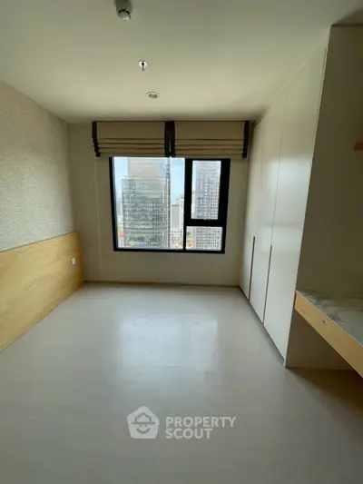 Spacious bedroom with city view and ample natural light