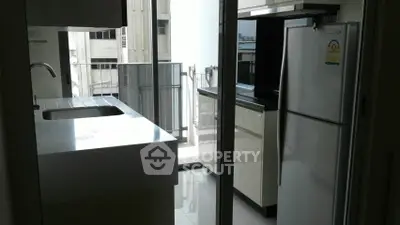 Modern kitchen with sleek design and balcony view in urban apartment