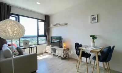 Bright and modern living room with scenic view, cozy seating, and stylish dining area.