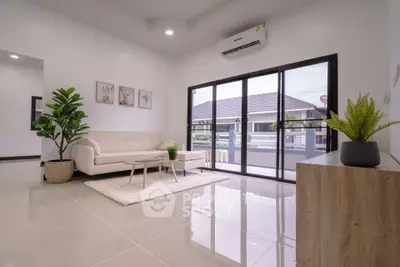 Spacious modern living room with large windows and elegant decor