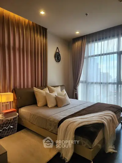 Luxurious bedroom with elegant decor and city view, featuring plush bedding and ambient lighting.