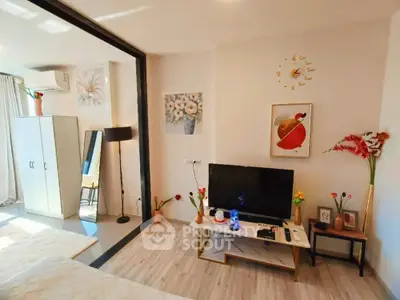 Charming living room with modern decor, TV setup, and elegant wall art, perfect for cozy relaxation.