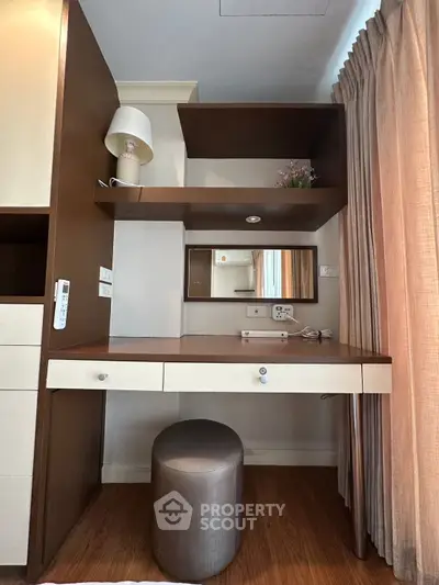 Stylish study nook with modern desk, shelves, and elegant decor in cozy apartment.