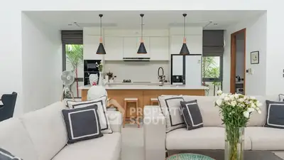 Modern open-plan living room with stylish kitchen and elegant decor