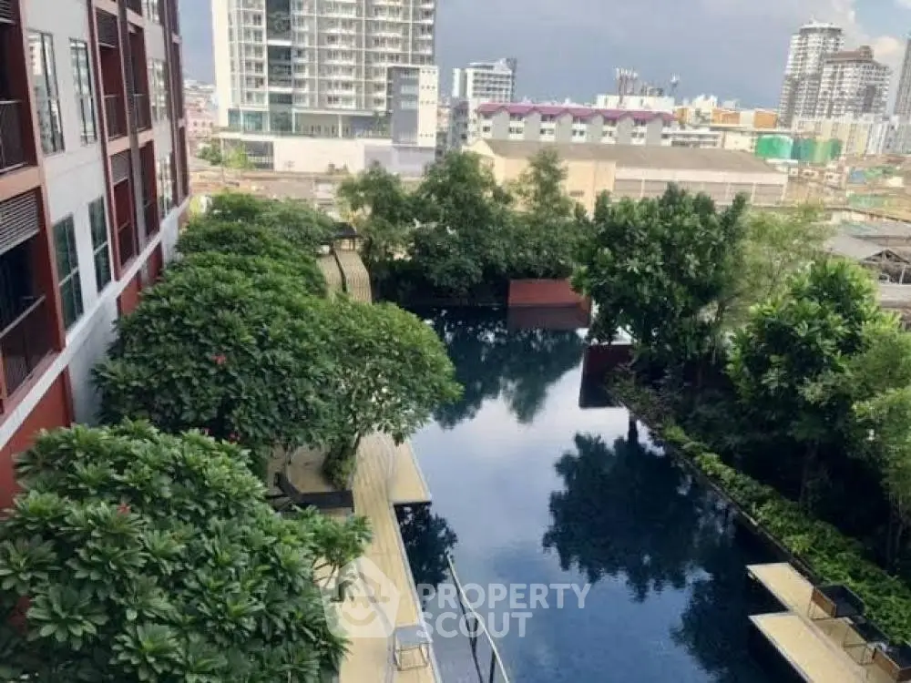 Luxurious urban apartment with stunning pool and lush greenery view