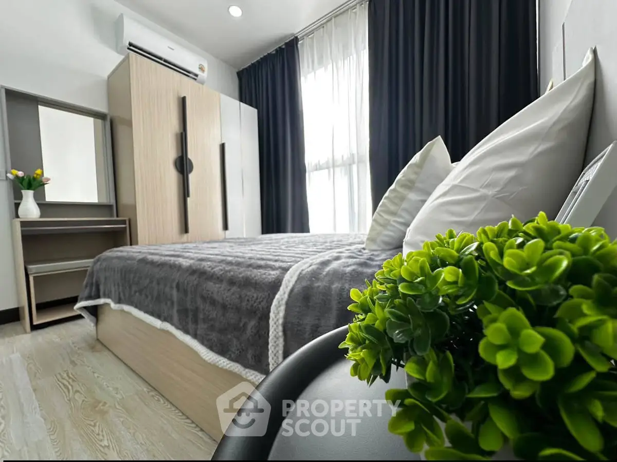 Modern bedroom with stylish decor, featuring a cozy bed, sleek wardrobe, and lush greenery for a serene ambiance.