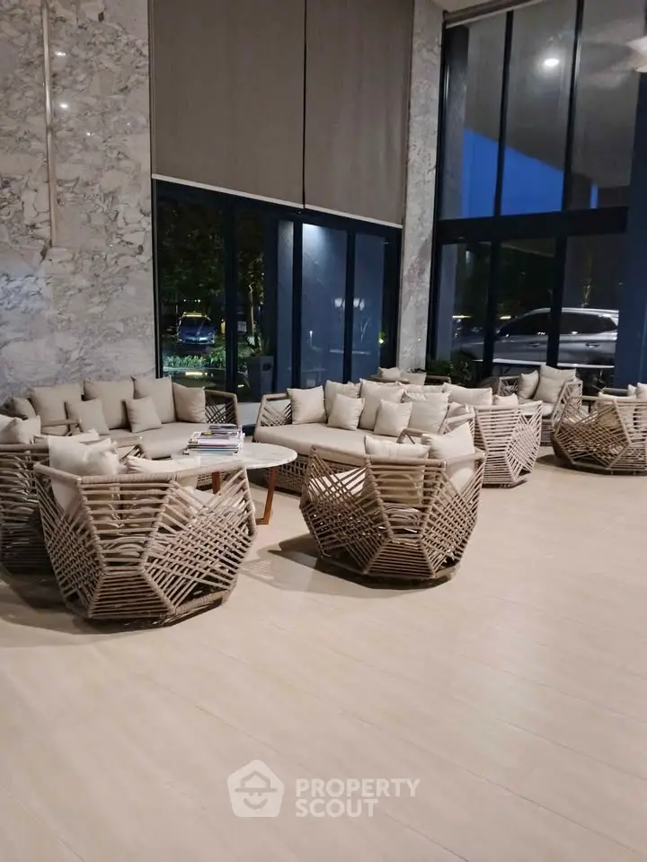 Luxurious modern lobby with stylish seating and floor-to-ceiling windows offering a serene ambiance.