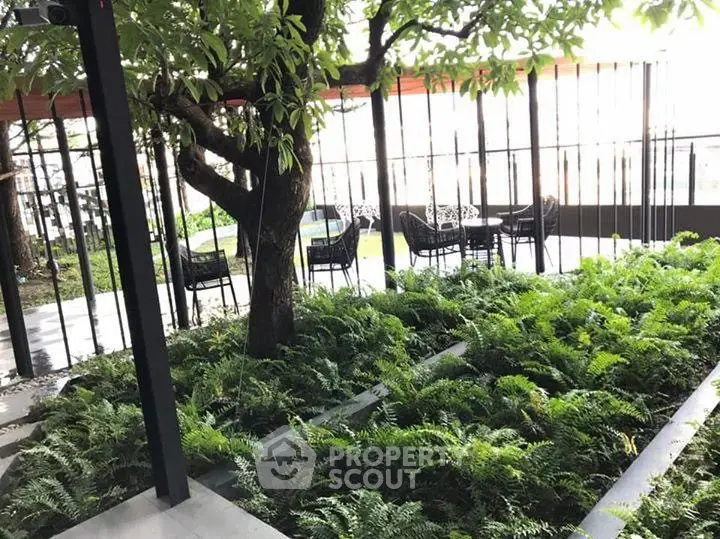 Charming garden area with lush greenery and outdoor seating, perfect for relaxation and gatherings.