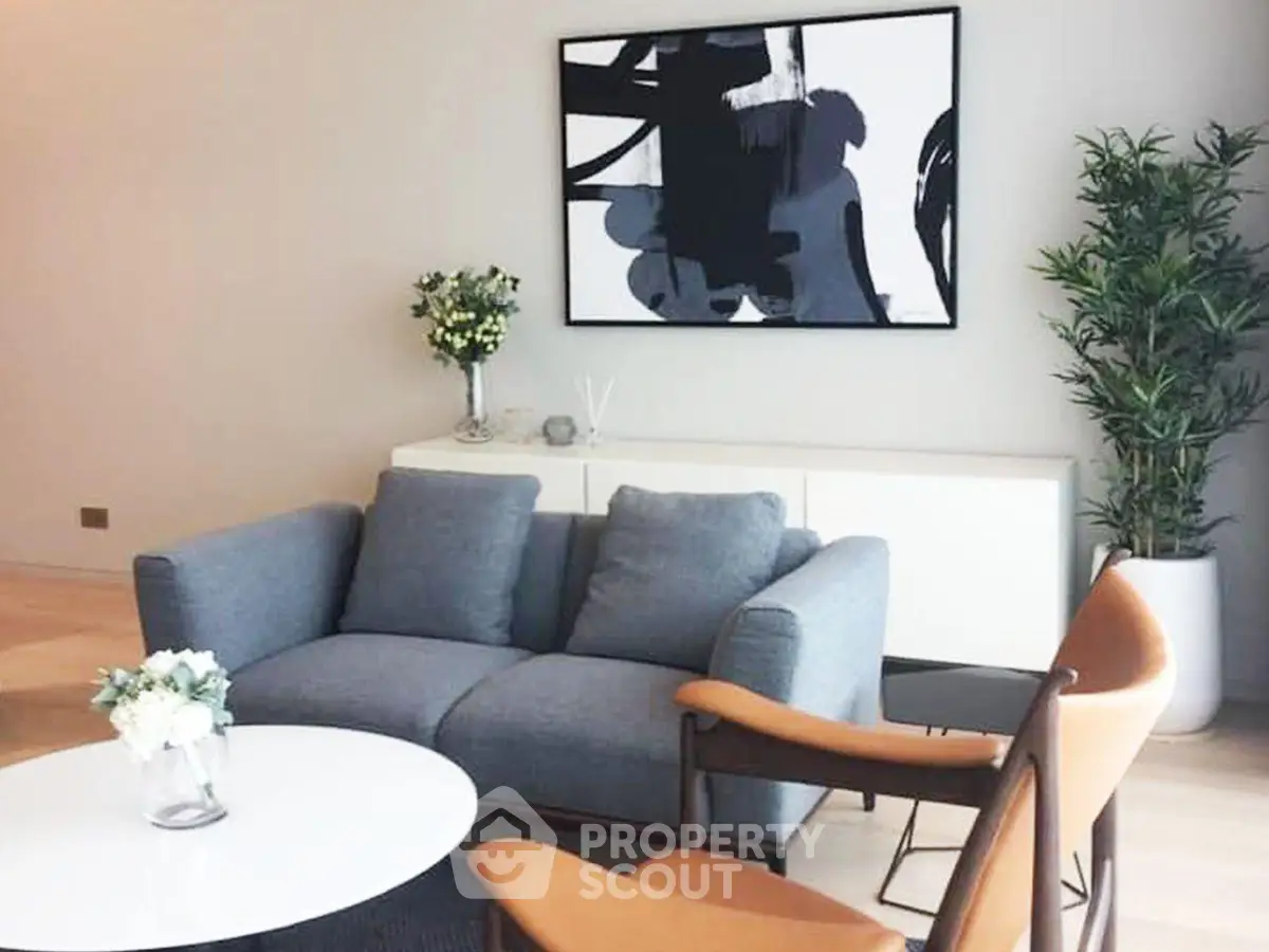 Stylish modern living room with cozy sofa and abstract art