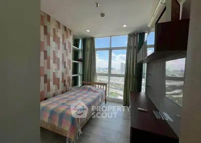 Modern bedroom with large window offering stunning city view, featuring stylish decor and ample natural light.