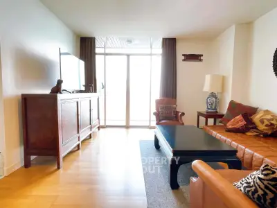 Spacious living room with elegant furniture and large window for natural light.