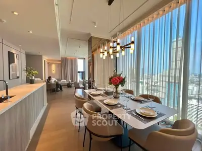 Luxurious open-plan living and dining area with panoramic city views and elegant decor.