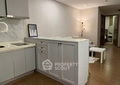 Modern open-layout kitchen and living room with stylish decor and cozy ambiance.