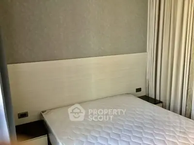 Modern bedroom with minimalist design and neutral tones, featuring a comfortable bed and stylish curtains.